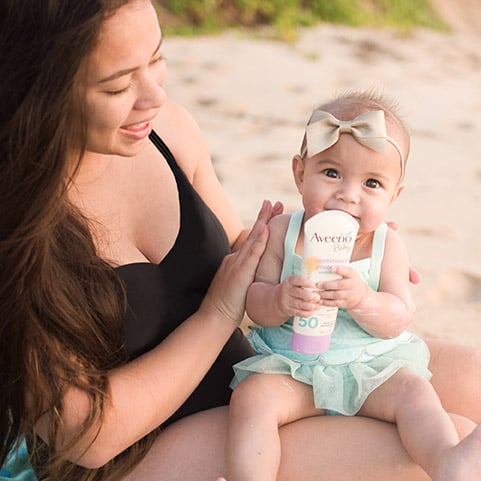 Mother and baby using Aveeno sunscreen